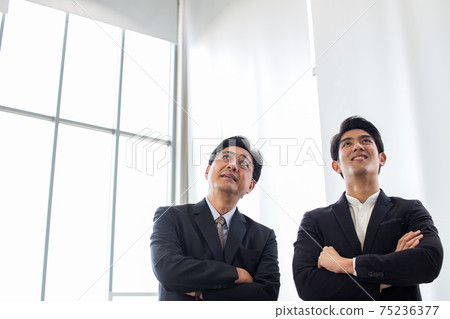 group of asia successful business people standing cross arm.Diverse business team smiling looking up in office group of asia successful business people standing cross arm.Diverse business team smiling looking up in office 75236377