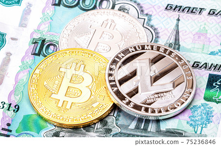 Cryptocurrency coins lying on the russian ruble banknotes 75236846