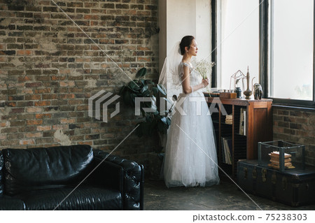 Portrait of a bride in a wedding dress Portrait of a bride in a wedding dress 75238303