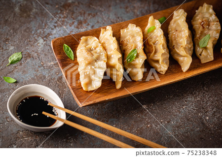 Asian dumplings with soy sauce 75238348