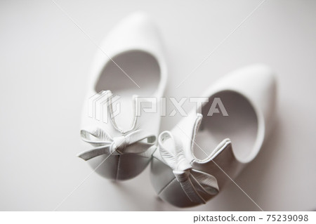Gorgeous wedding shoes on a white background Gorgeous wedding shoes on a white background 75239098