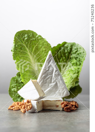 Fresh Brie cheese with lettuce and walnuts. 75240236