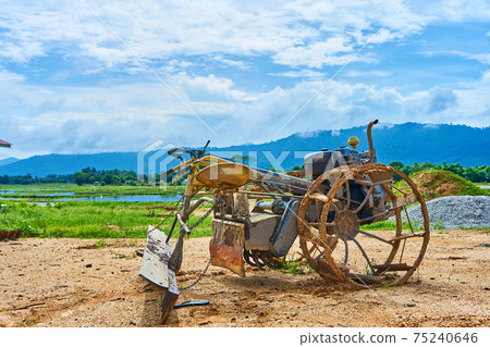 A strange homemade tool for plowing a field from a rebuilt motorbike. Agricultural village in Asia 75240646