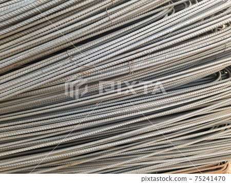 Stack of heavy metal reinforcement bars with periodic profile texture. Close up steel construction armature. Abstract industrial background concept. Copy space. Stack of heavy metal reinforcement bars with periodic profile texture. Close up steel construction armature. Abstract industrial background concept. Copy space. 75241470