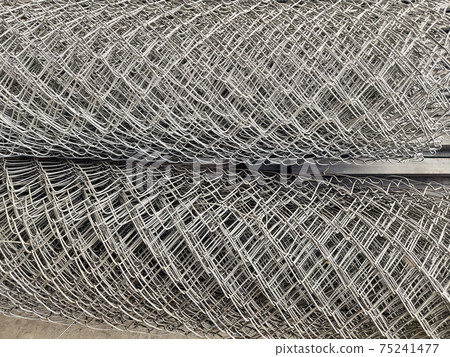 Metal bars background in diagonal lines close-up, industrial mesh of steel wire texture, building material Metal bars background in diagonal lines close-up, industrial mesh of steel wire texture, building material 75241477