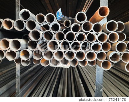 Rows of Steel Round Bar storage and stacking in the warehouse for industrial construction. Black and white with Shallow focus. Rows of Steel Round Bar storage and stacking in the warehouse for industrial construction. Black and white with Shallow focus. 75241478