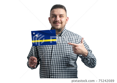 White guy holding a flag of Curacao and points the finger of the other hand at the flag isolated on a white background White guy holding a flag of Curacao and points the finger of the other hand at the flag isolated on a white background 75242089