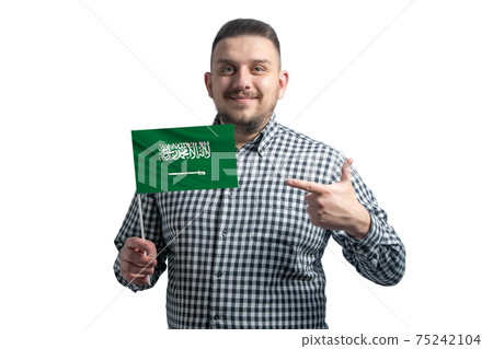 White guy holding a flag of Saudi Arabia and points the finger of the other hand at the flag isolated on a white background White guy holding a flag of Saudi Arabia and points the finger of the other hand at the flag isolated on a white background 75242104