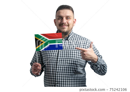 White guy holding a flag of South African Republic and points the finger of the other hand at the flag isolated on a white background 75242106