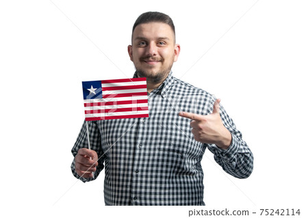 White guy holding a flag of Liberia and points the finger of the other hand at the flag isolated on a white background White guy holding a flag of Liberia and points the finger of the other hand at the flag isolated on a white background 75242114