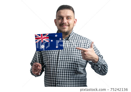 White guy holding a flag of Australia and points the finger of the other hand at the flag isolated on a white background White guy holding a flag of Australia and points the finger of the other hand at the flag isolated on a white background 75242136