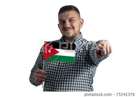 White guy holding a flag of Jordan and points forward in front of him isolated on a white background 75242378