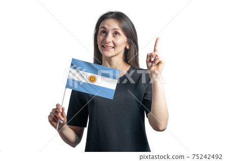 Happy young white woman holding flag of Argentina and points thumbs up isolated on a white background 75242492