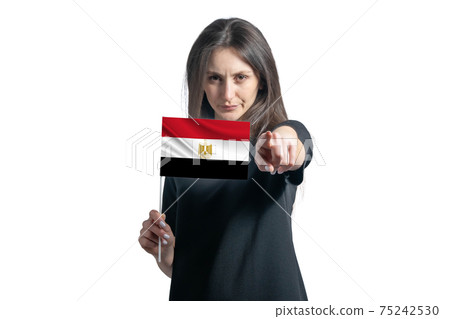 Happy young white woman holding flag of Egypt and points forward in front of him isolated on a white background Happy young white woman holding flag of Egypt and points forward in front of him isolated on a white background 75242530
