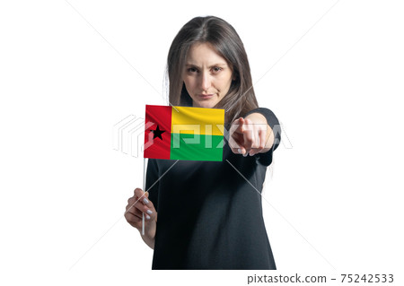 Happy young white woman holding flag of Guinea-Bissau and points forward in front of him isolated on a white background Happy young white woman holding flag of Guinea-Bissau and points forward in front of him isolated on a white background 75242533