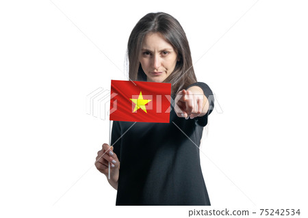 Happy young white woman holding flag of Vietnam and points forward in front of him isolated on a white background Happy young white woman holding flag of Vietnam and points forward in front of him isolated on a white background 75242534