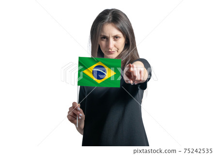 Happy young white woman holding flag of Brazil and points forward in front of him isolated on a white background Happy young white woman holding flag of Brazil and points forward in front of him isolated on a white background 75242535