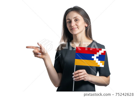 Happy young white woman holding flag Nagorno-Karabakh Republic and points to the left isolated on a white background Happy young white woman holding flag Nagorno-Karabakh Republic and points to the left isolated on a white background 75242628