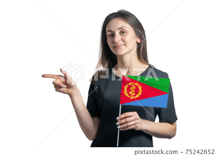 Happy young white woman holding flag Eritrea and points to the left isolated on a white background Happy young white woman holding flag Eritrea and points to the left isolated on a white background 75242652