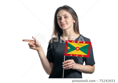 Happy young white woman holding flag Grenada and points to the left isolated on a white background Happy young white woman holding flag Grenada and points to the left isolated on a white background 75242653