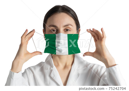 Respirator with flag of Nigeria Doctor puts on medical face mask isolated on white background 75242704