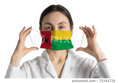 Respirator with flag of Guinea-Bissau Doctor puts on medical face mask isolated on white background Respirator with flag of Guinea-Bissau Doctor puts on medical face mask isolated on white background 75242716