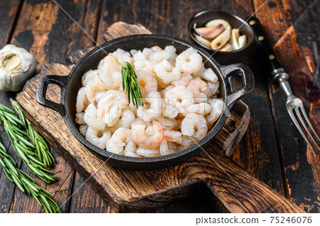 Boiled Peeled Shrimps, Prawns in a pan. Dark Wooden background. top view Boiled Peeled Shrimps, Prawns in a pan. Dark Wooden background. top view 75246076