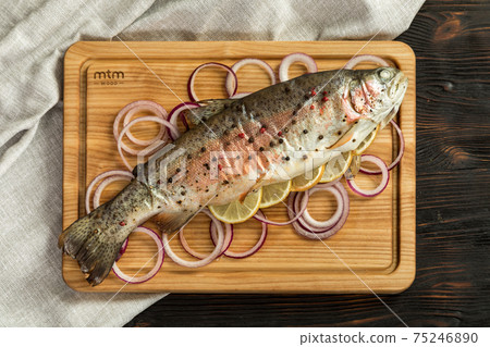 baked rainbow trout on a wooden board for serving baked rainbow trout on a wooden board for serving 75246890