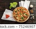 Delicious pizza on a wooden cutting board 75246907