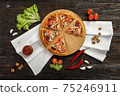 Delicious pizza on a wooden cutting board 75246911