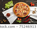 Delicious pizza on a wooden cutting board 75246913