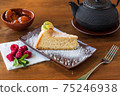A slice of tender cheesecake with lemon 75246938