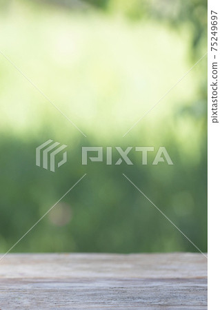 Abstract natural green bokeh background with wood table. Vertical 75249697