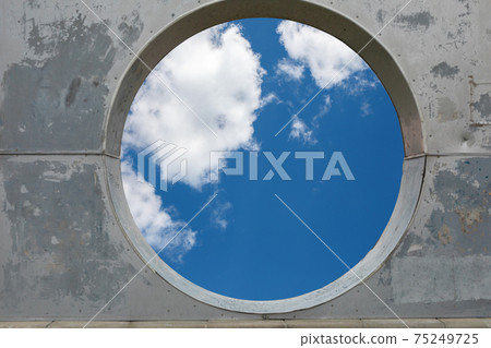 blue sky hole in aged concrete wall background blue sky hole in aged concrete wall background 75249725