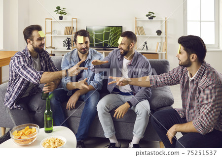 Bunch of young friends having a party, playing games and enjoying fun time together 75251537