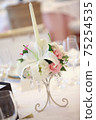 Candles with floral decorations used at wedding receptions 75254535