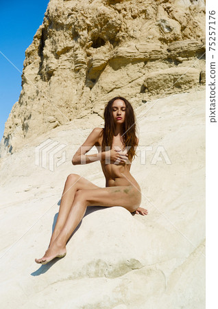 Beautiful nude woman with nice tan on the beach 75257176