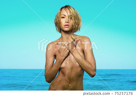 Beautiful nude woman with nice tan on the beach Beautiful nude woman with nice tan on the beach 75257178