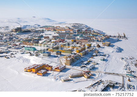 Winter landscape with the northern city of Anadyr. The administrative center of Chukotka and the most eastern city of Russia. Aerial photography of a small arctic city with colorful buildings. 75257752