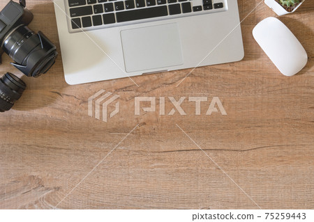 Wood photographer desk table with camera, lens, laptop and supplies. Top view with copy space, flat lay. 75259443