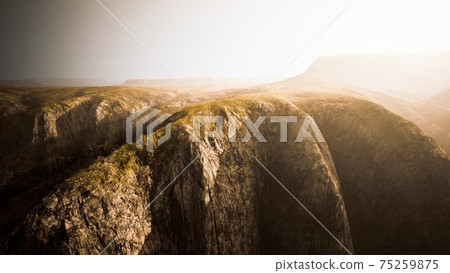 dry yellow grass on the rocky mountain with heavy fog 75259875