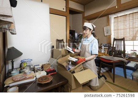 Female worker cleaning up a messy room Female worker cleaning up a messy room 75261598