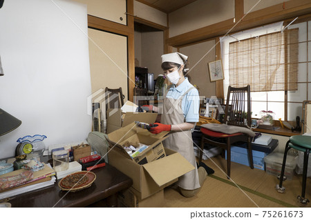 Female worker cleaning up a messy room 75261673