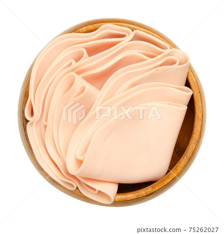 Vegetarian sausage, cold cut, in a wooden bowl. Thin slices of meatless Extrawurst, similar to Lyoner or Bologna sausage. Scalded protein of milk, egg white and peas. Isolated over white, food photo. Vegetarian sausage, cold cut, in a wooden bowl. Thin slices of meatless Extrawurst, similar to Lyoner or Bologna sausage. Scalded protein of milk, egg white and peas. Isolated over white, food photo. 75262027