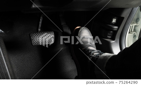 Accelerator and breaking pedal in a car. Close up the foot pressing foot pedal of a car to drive ahead. Driver driving the car by pushing accelerator pedals of the car. inside vehicle.  75264290