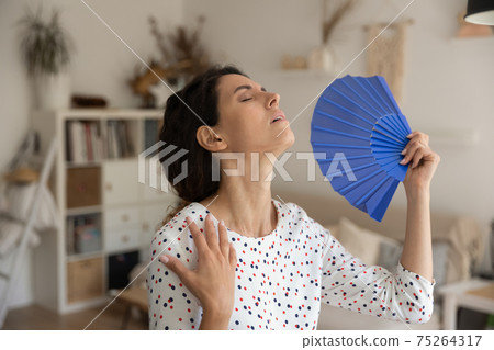 Exhausted young housewife suffer from extra hot temperature wave herself Exhausted young housewife suffer from extra hot temperature wave herself 75264317