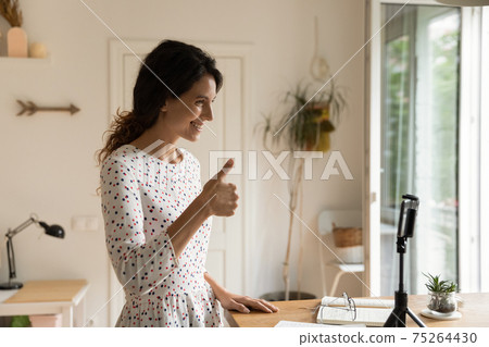 Enthusiastic woman teacher talk on smartphone webcam show thumb up 75264430