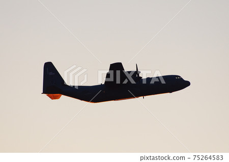 C-130 Hercules flying in the evening 75264583
