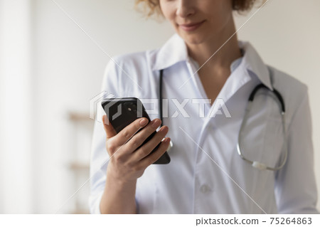 Close up of female doctor use smartphone in hospital Close up of female doctor use smartphone in hospital 75264863