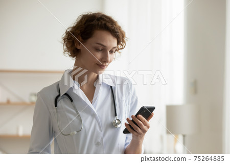 Female doctor use cellphone consulting patient in hospital 75264885
